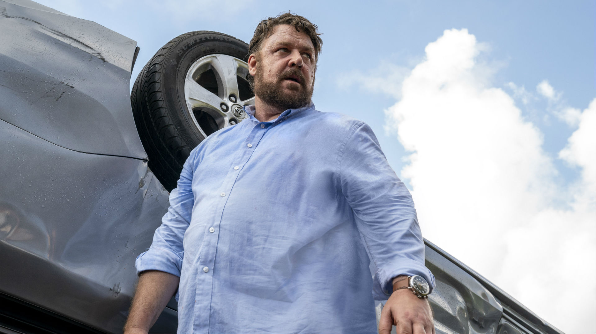 Russell Crowe wearing a light blue polo long sleeves