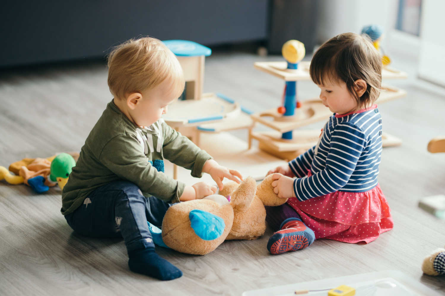 Two kids playing with a toy