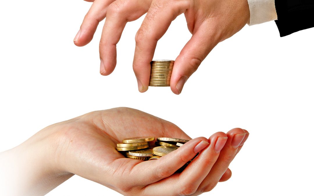 A hand transfering coins into another person's hand