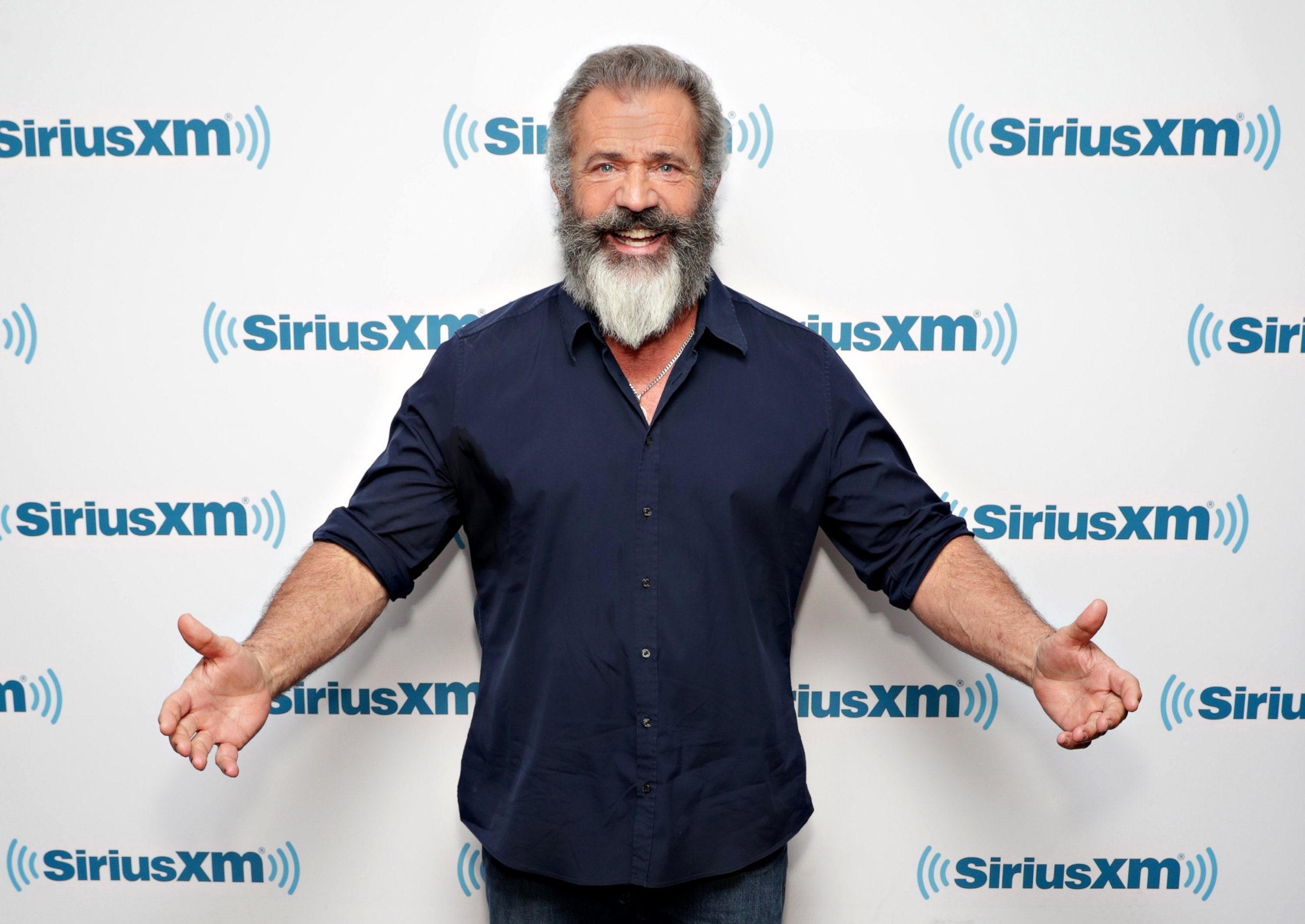 Mel Gibson wearing a blue long sleeves polo