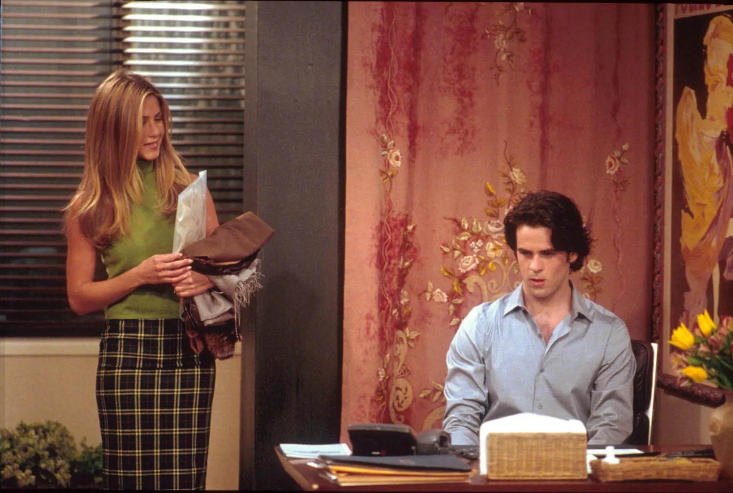 Rachel Green in a green top and a plaid skirt