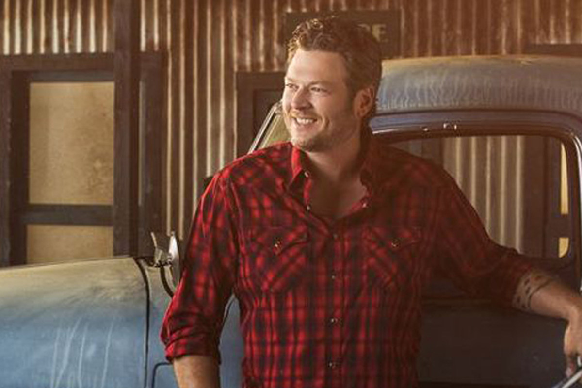 Blake Shelton wearing a red checkered pooloo on a car