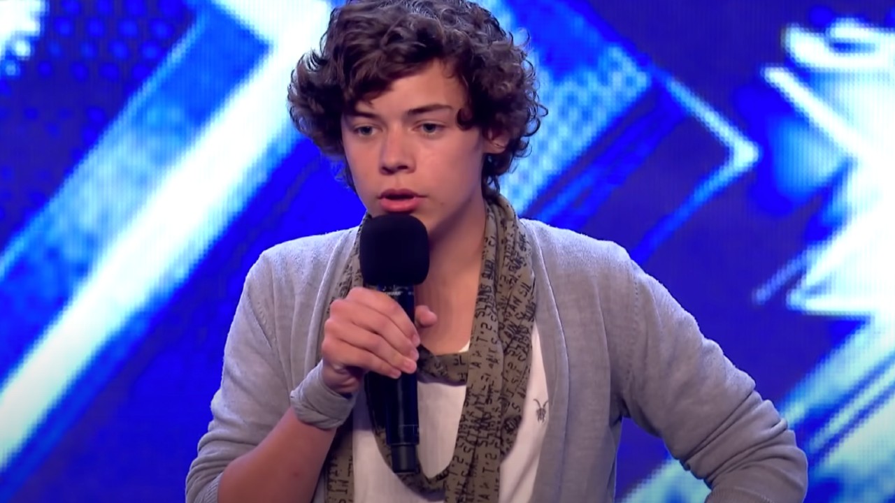 Harry Styles wearing a gray cardigan on X Factor