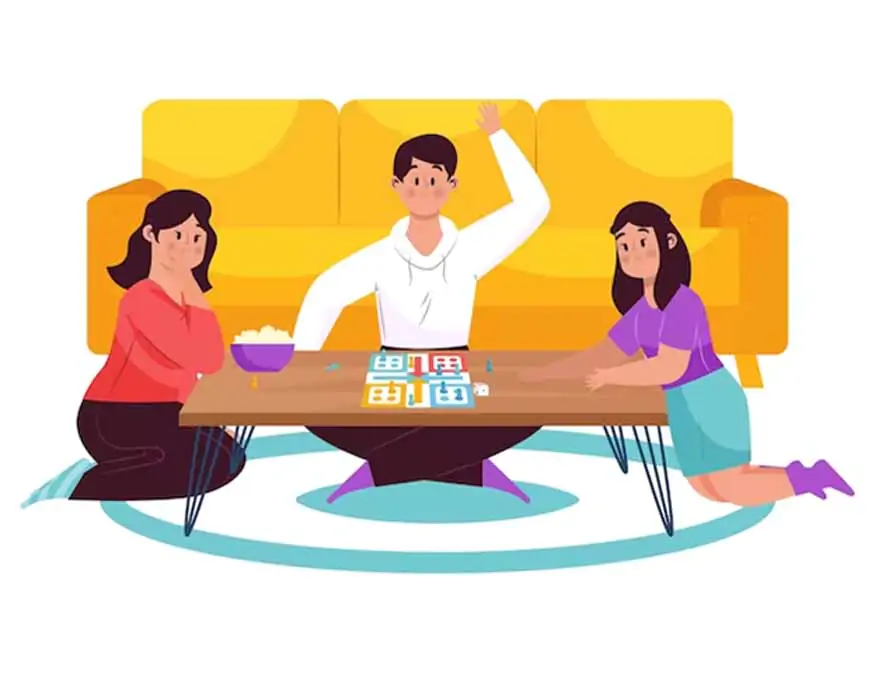 Three people engaging in a board game at a table, with one individual appearing excited or triumphant, possibly signaling a win or successful move in the game.