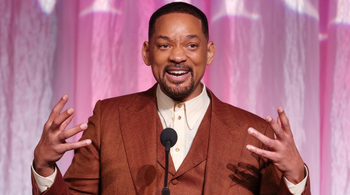 Will Smith wearing a rust orange suit