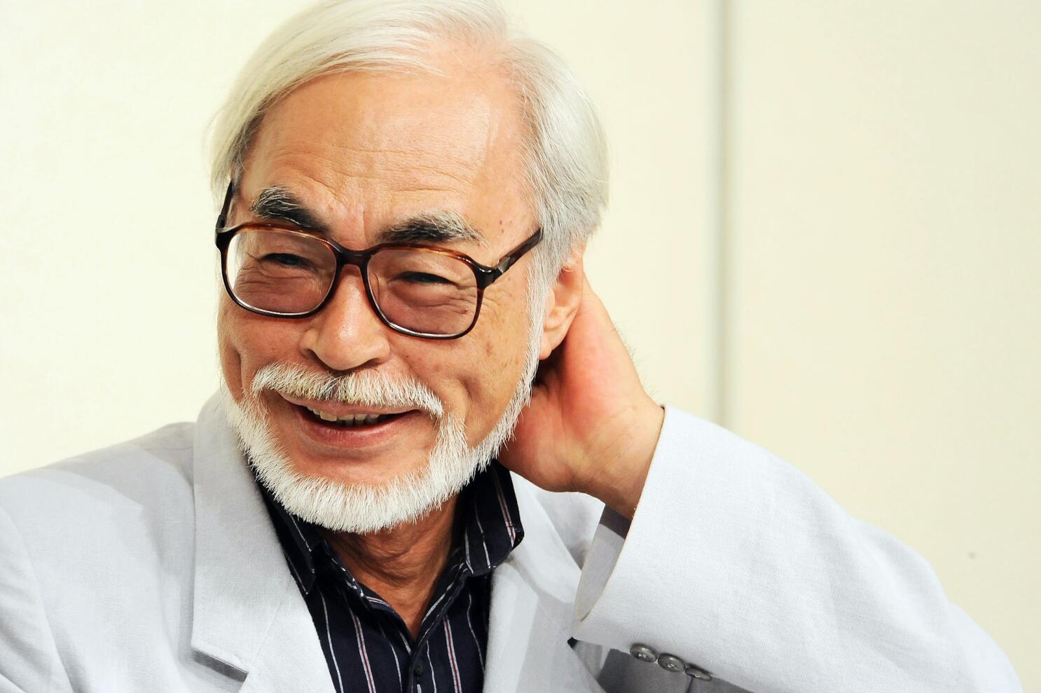 Hayao Miyazaki wearing a gray coat