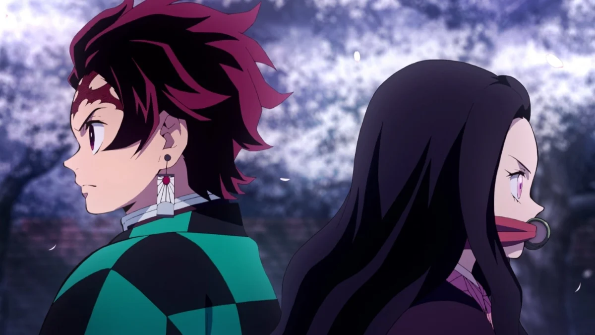 Tanjiro and Nezuko Kamado from "Demon Slayer," highlighting the strong bond and determination that exists between the sibling duo, set against a vivid, blurred background.
