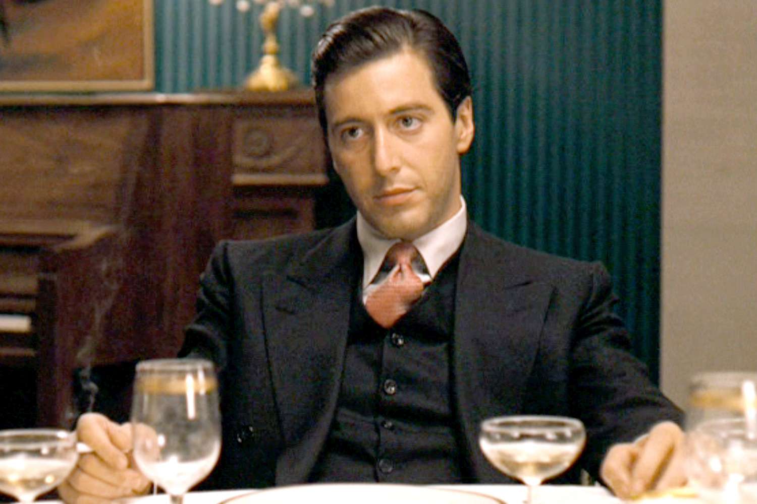 Young Al Pacino wearing a black suit