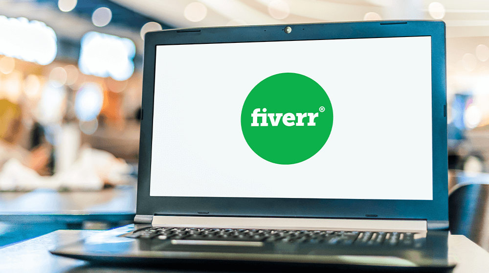 A laptop displaying the Fiverr logo on its screen.