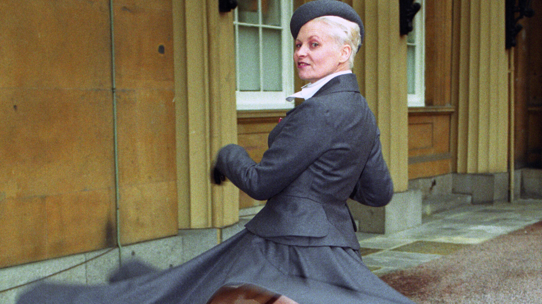 Vivienne Westwood wearing a gray coat dress