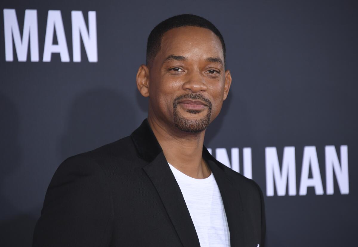 Will Smith wearing a black coat