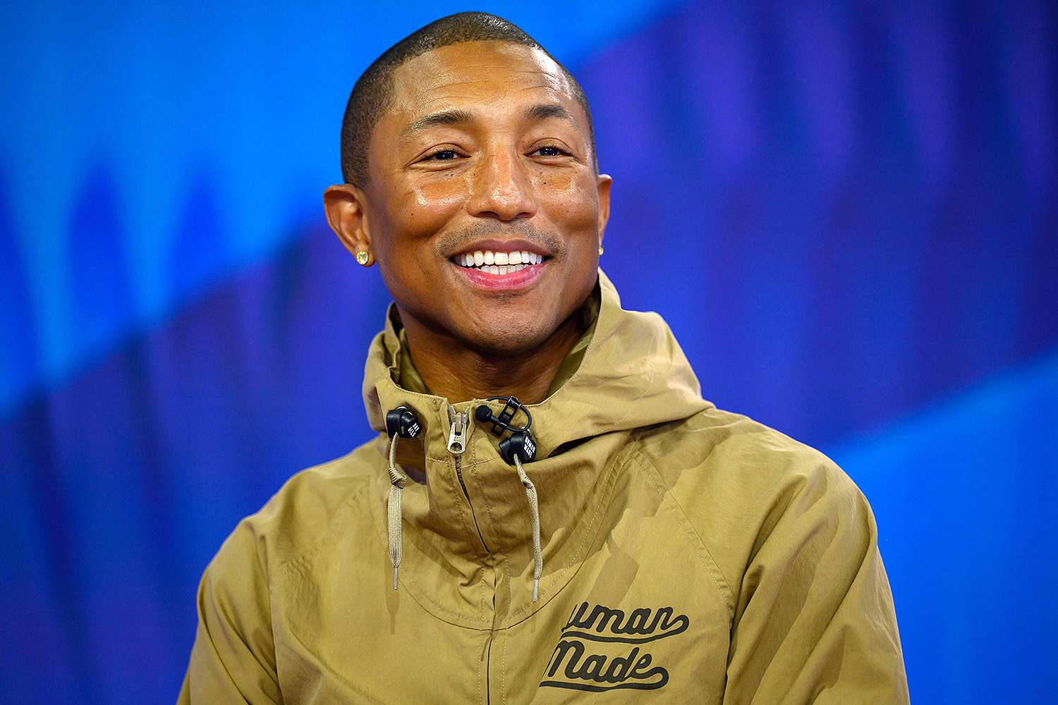 Pharrell Williams wearing a brown hoodie jacket