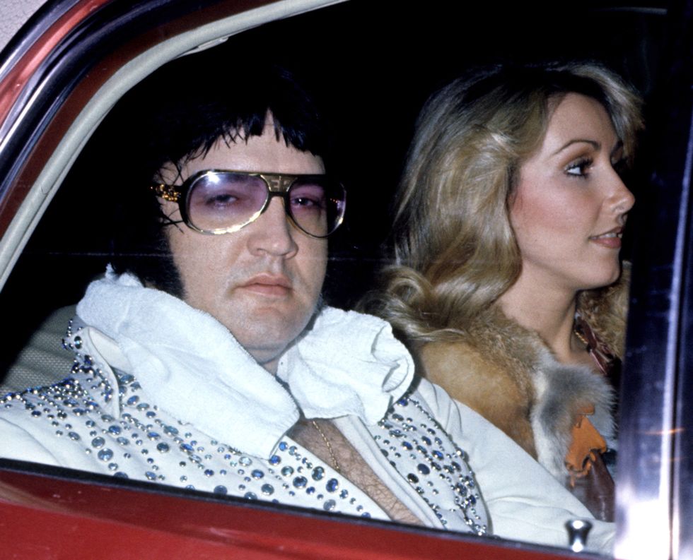 Elvis presley sitting in a car