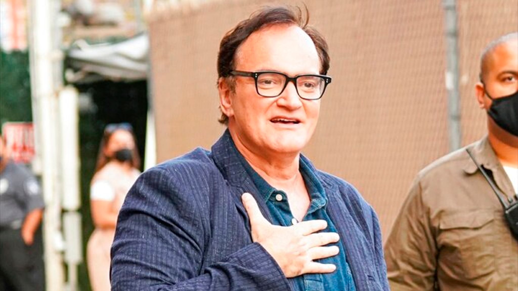 Quentin Tarantino wearing a blue flannel