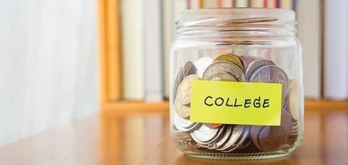 A college savings jar half filled with coins