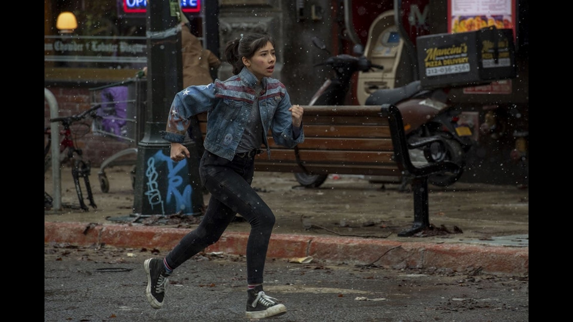 Xochitl Gomez running on a blue jackets and trousers in Doctor Strange
