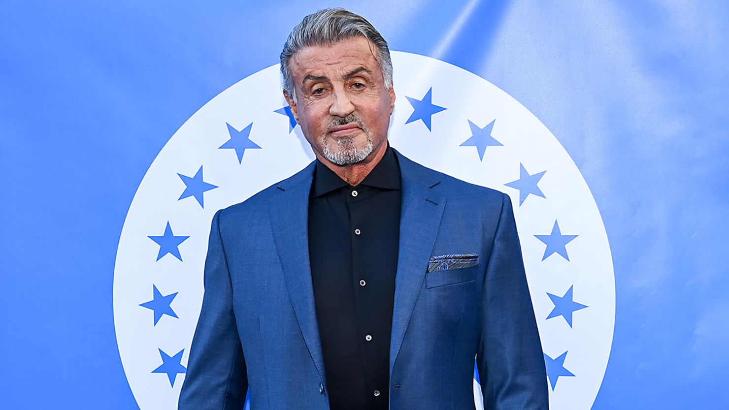 Sylvester Stallone wearing a blue coat