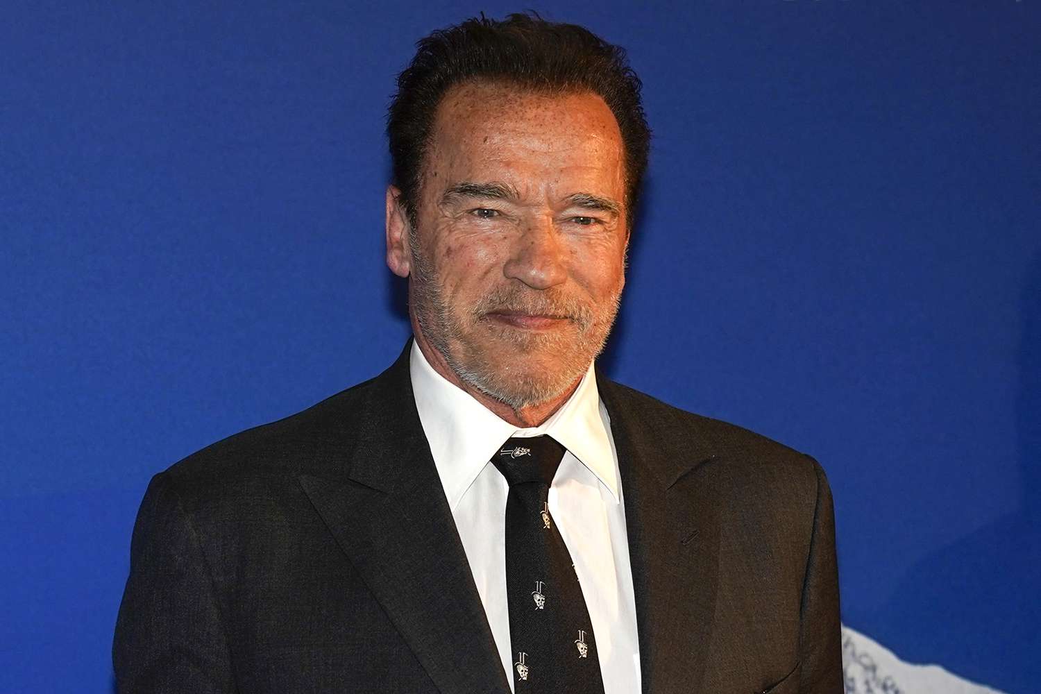 Arnold Schwarzenegger wearing a black suit