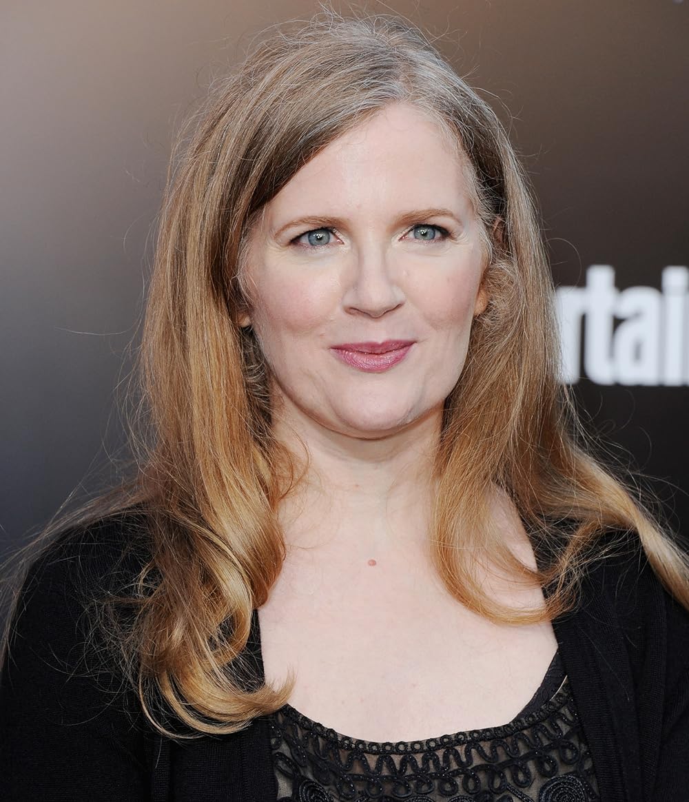 Suzanne Collins wearing a black dress and coat