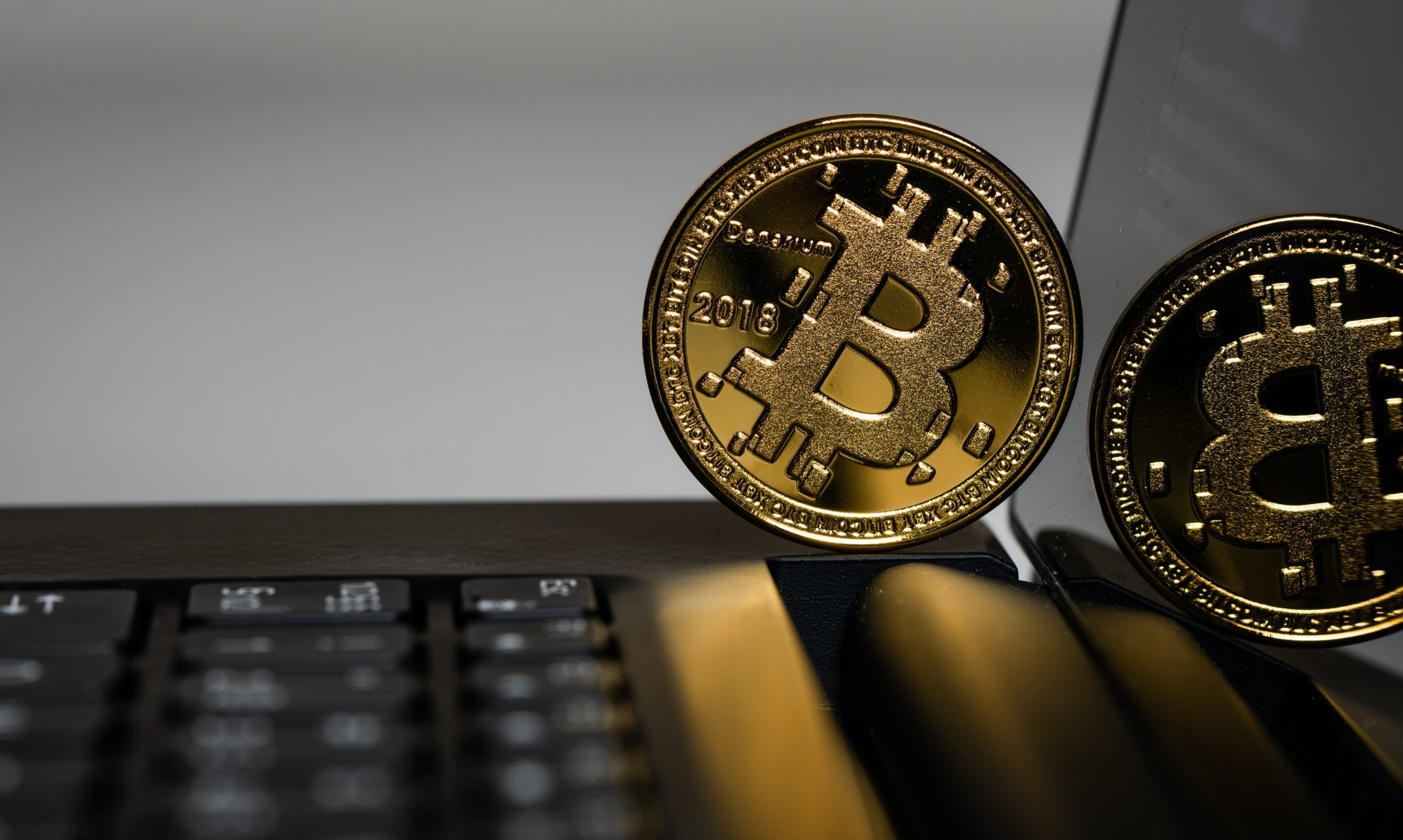 A bitcoin on the surface of a laptop