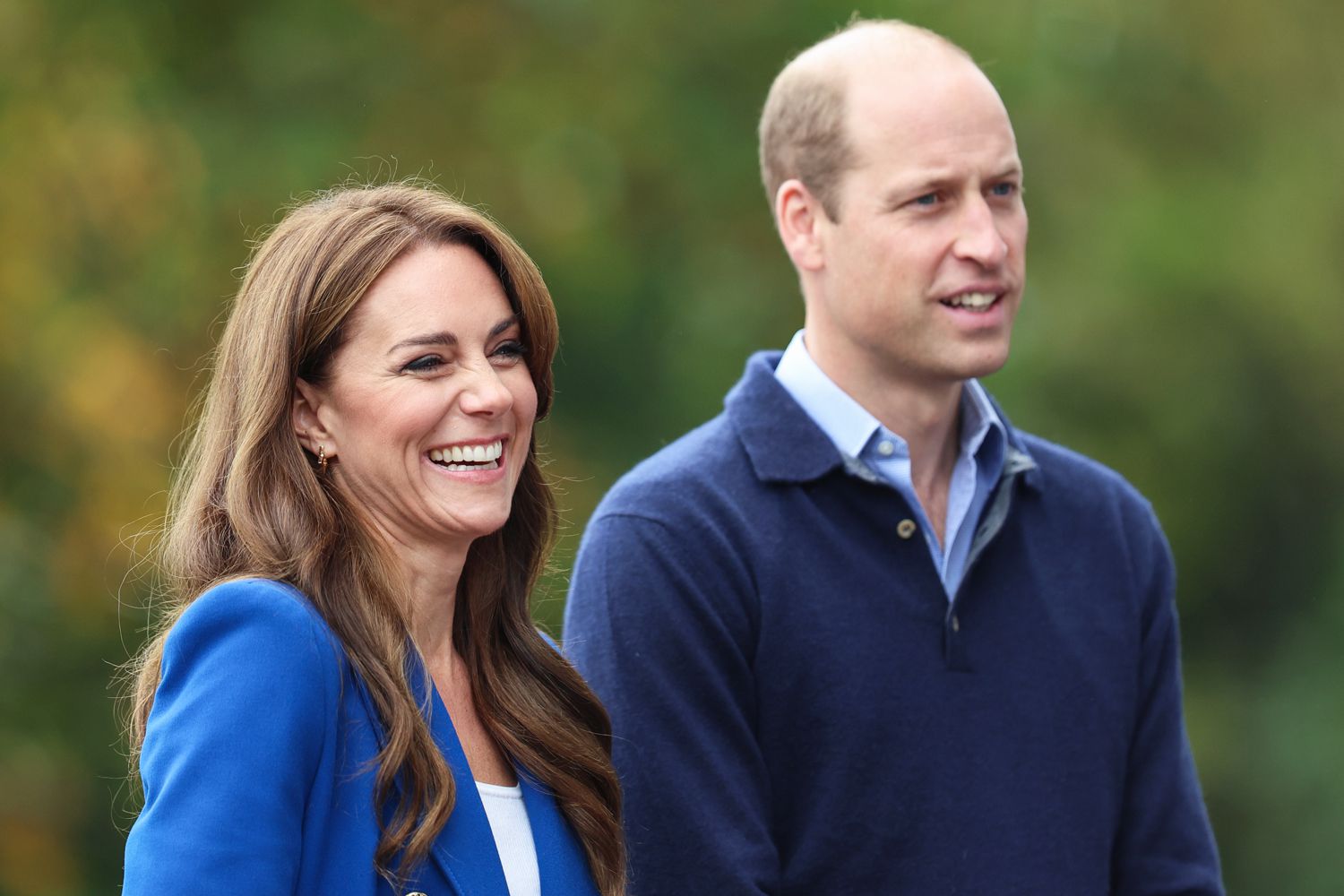 Prince William wearing a blue sweater and Kate Middleton wearing a blue coat