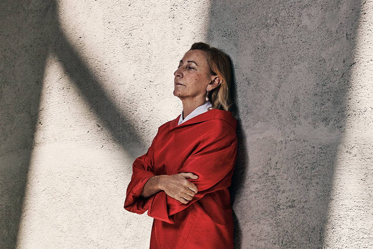 Miuccia Prada wearing a red coat