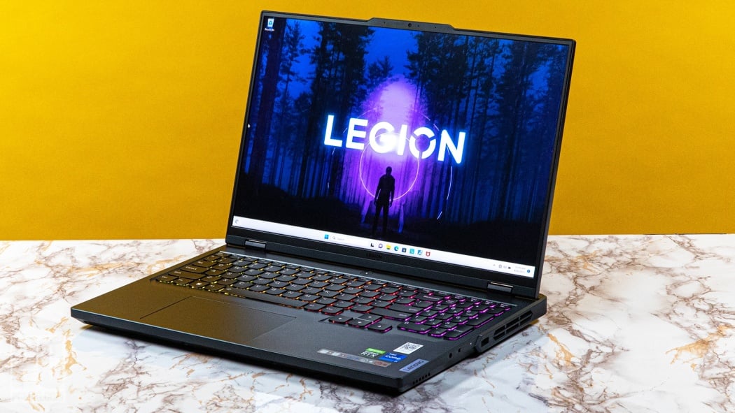A black Lenovo Legion Pro 5i laptop sitting on a marble platform