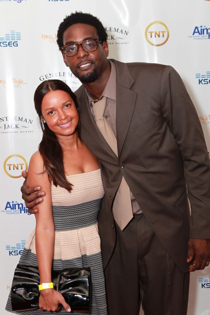 Erika Dates wearing a dress and Chris Webber wearing a brown suit