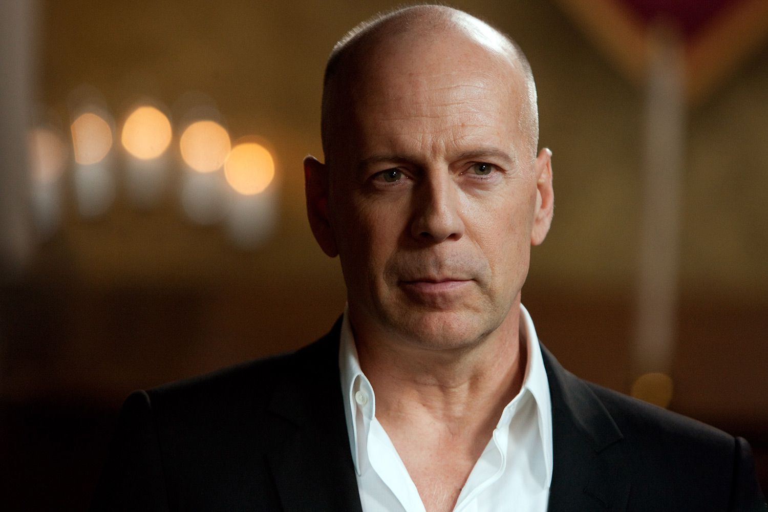 Bruce Willis wearing a black coat