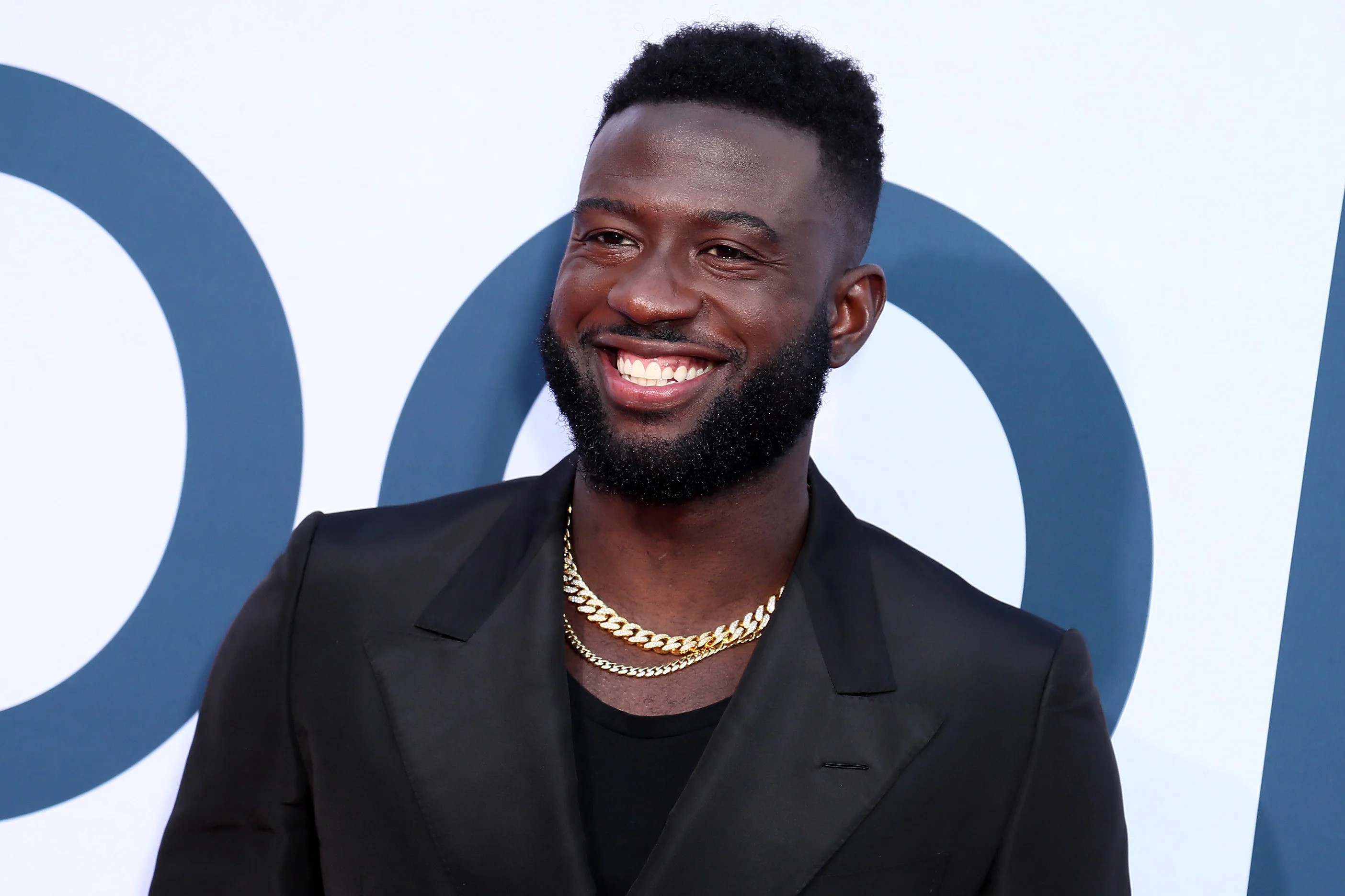 Sinqua Walls wearing a black suit at an event