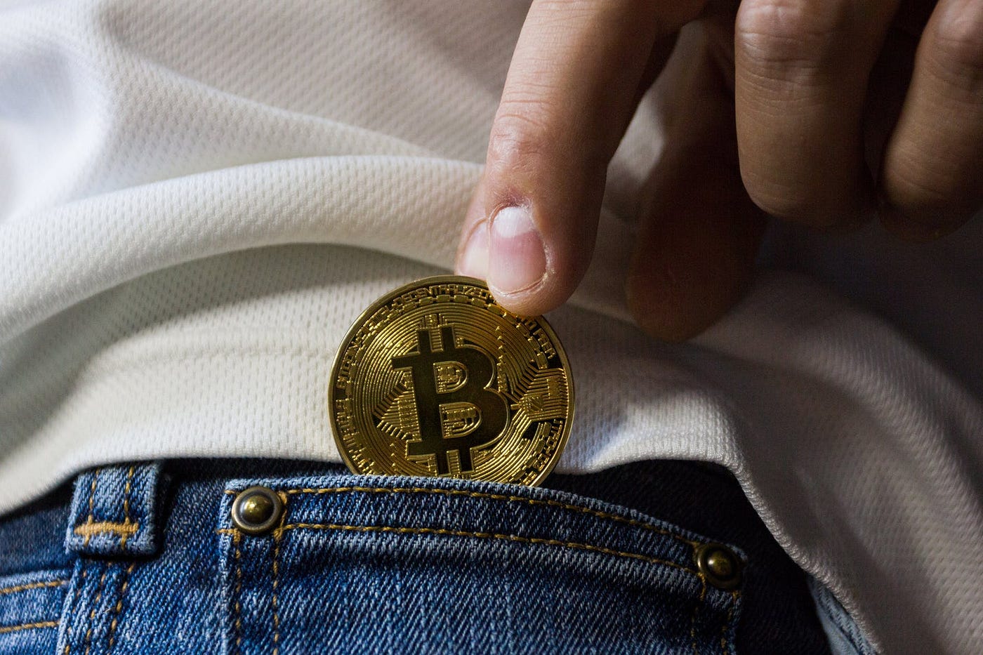 A person putting bitcoin in his pocket