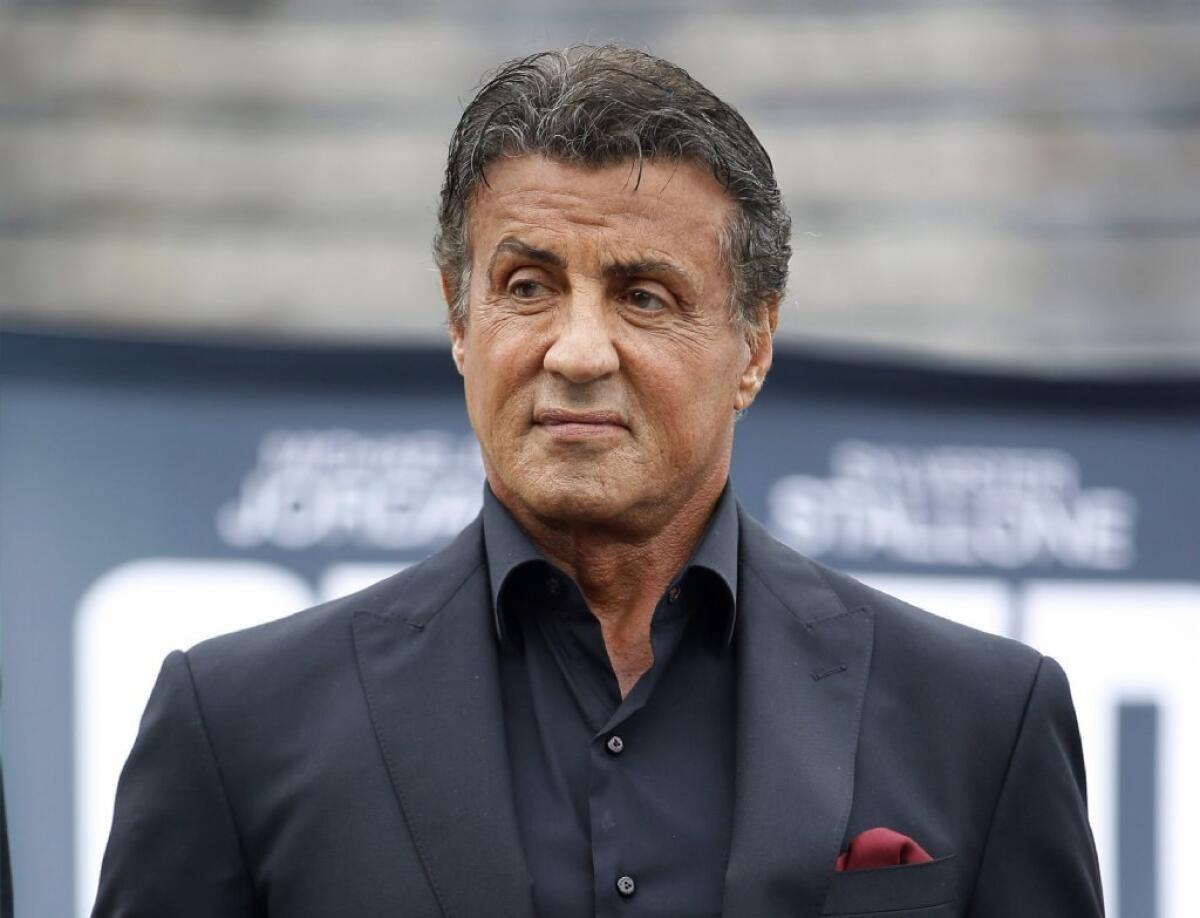Sylvester Stallone wearing a black suit
