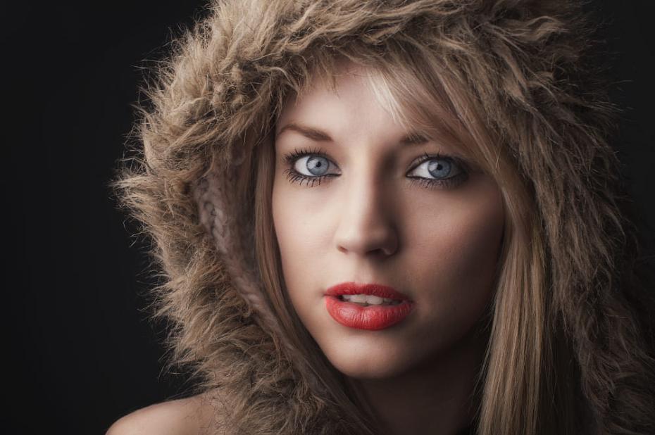 A woman on makeup wearing a furry hoodie