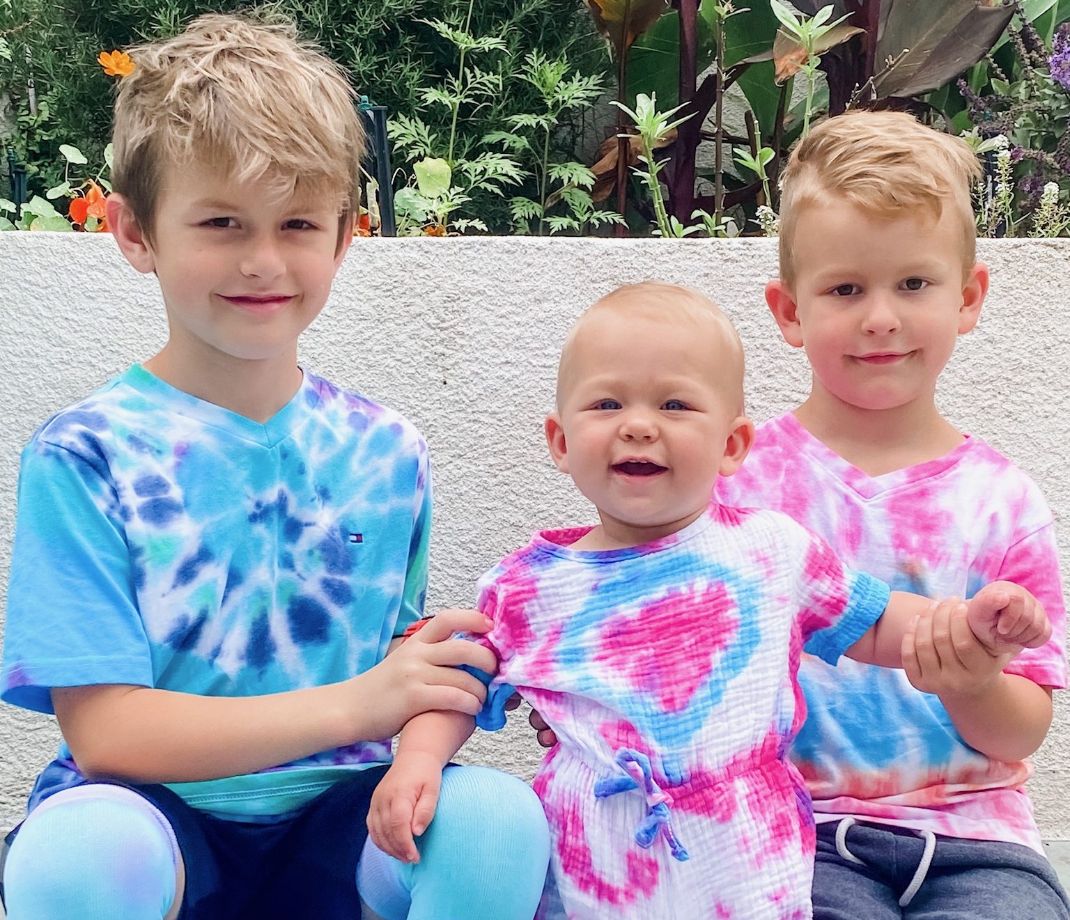 Three kids wearing a nice dyed clothe