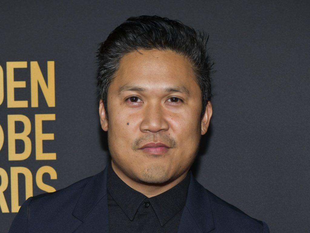 Dante Basco wearing a blue suit on a black shirt at an event