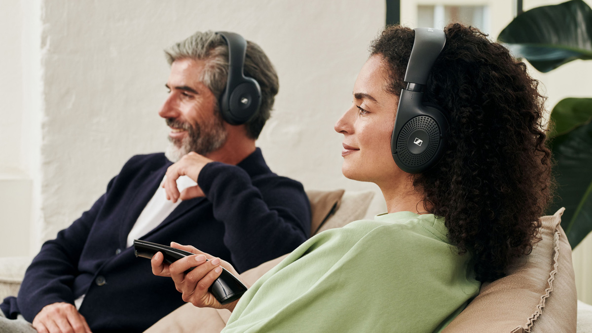 A man and a woman using a black wireless headset