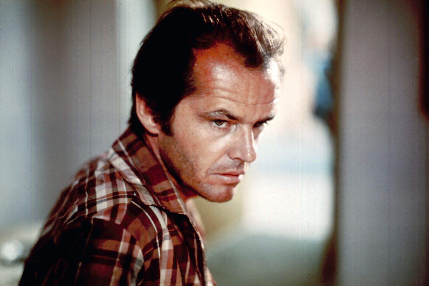 Jack Nicholson wearing a plaid polo