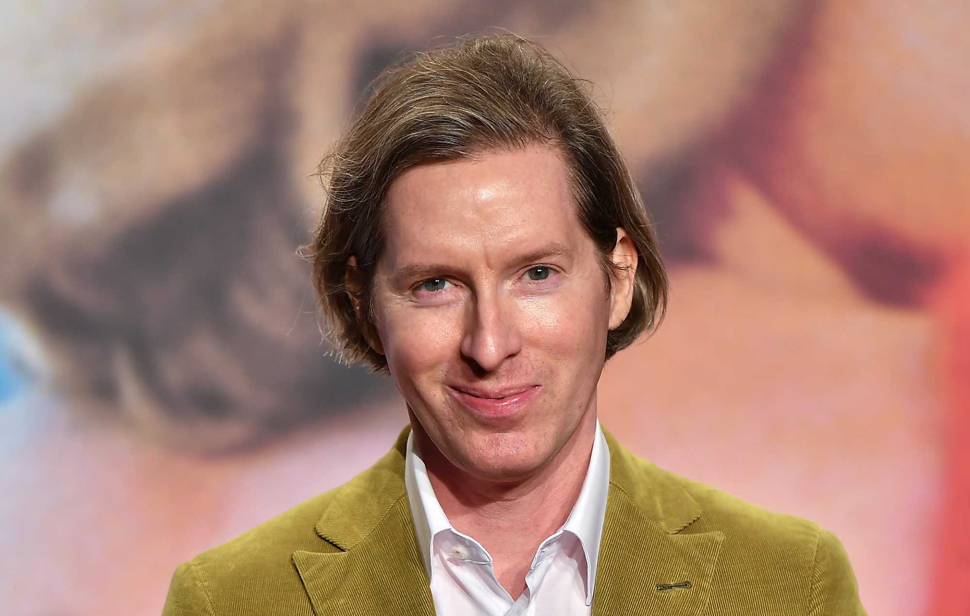 Wes Anderson wearing a green coat